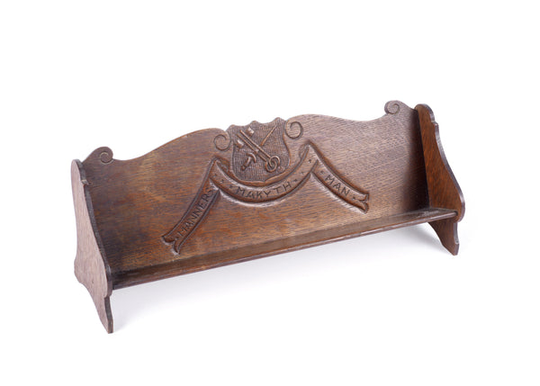 An early 20th century oak "Manners Makyth Man" letter rack