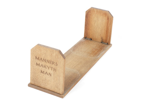 A 20th century folding oak 'Manners Makyth Man' book stand